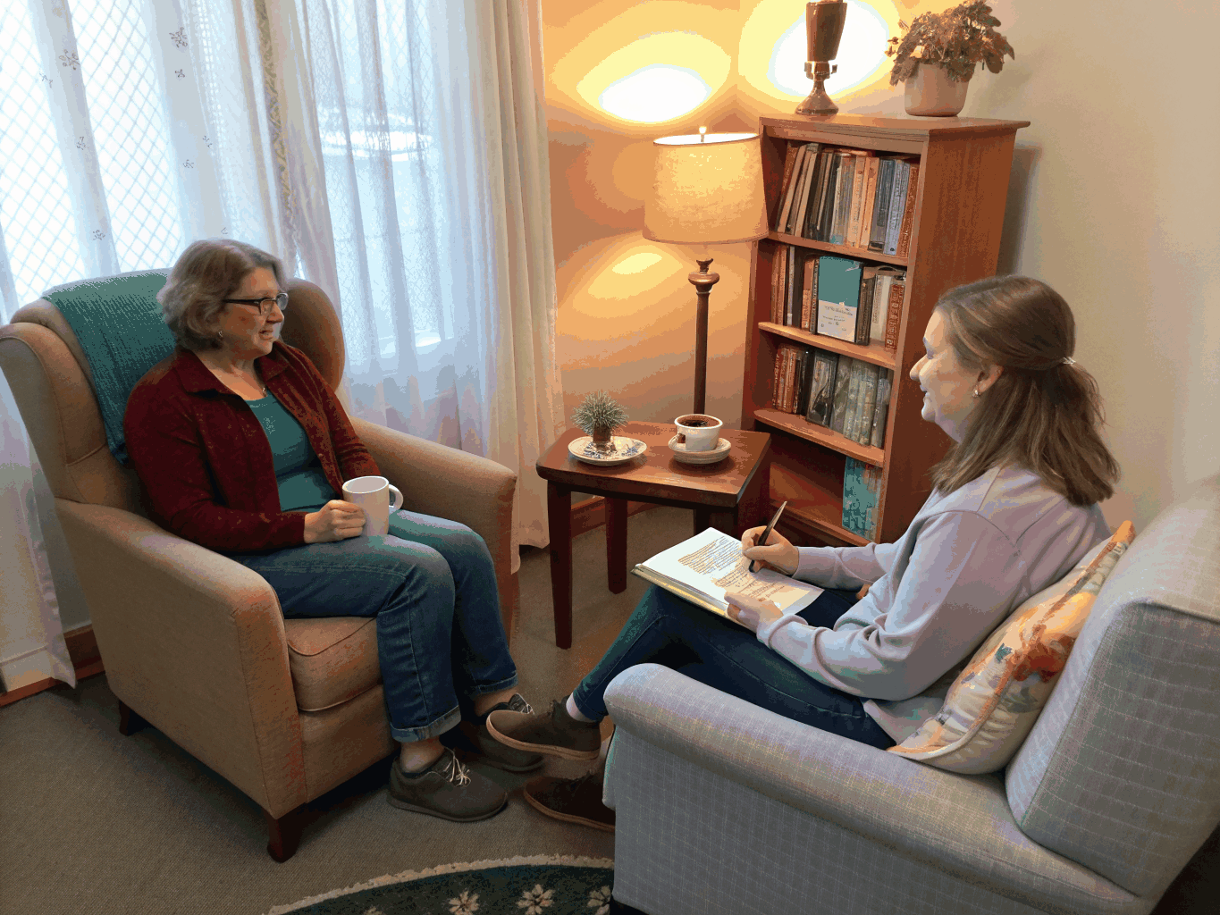 Reflective one-on-one counseling session in a warm, quiet room